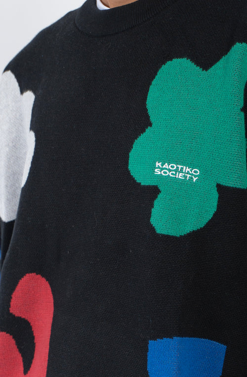 Jersey negro Kaotiko Black Breeze con gráficos geométricos multicolor y cuello redondo.