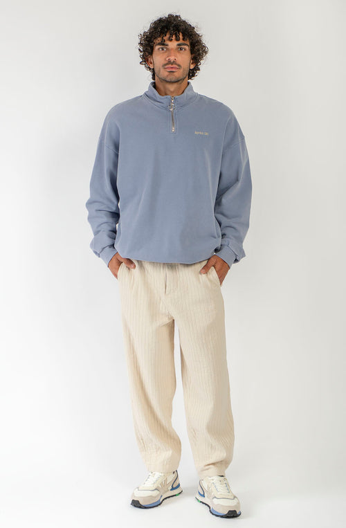 Pantalón unisex color natural con textura de rayas verticales, pierna recta y bolsillos laterales.