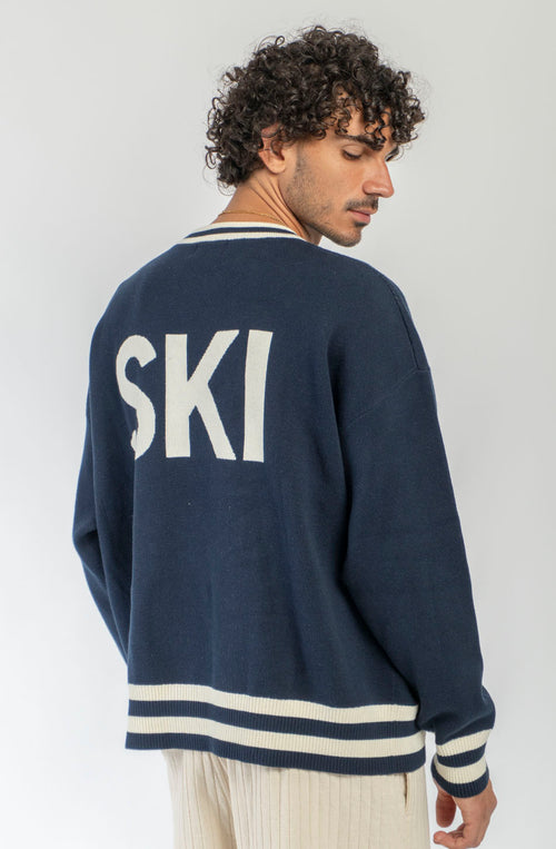 Jersey unisex azul marino de punto con gráfico APRÈS en el frontal, SKI en la espalda y detalles de canalé a contraste.